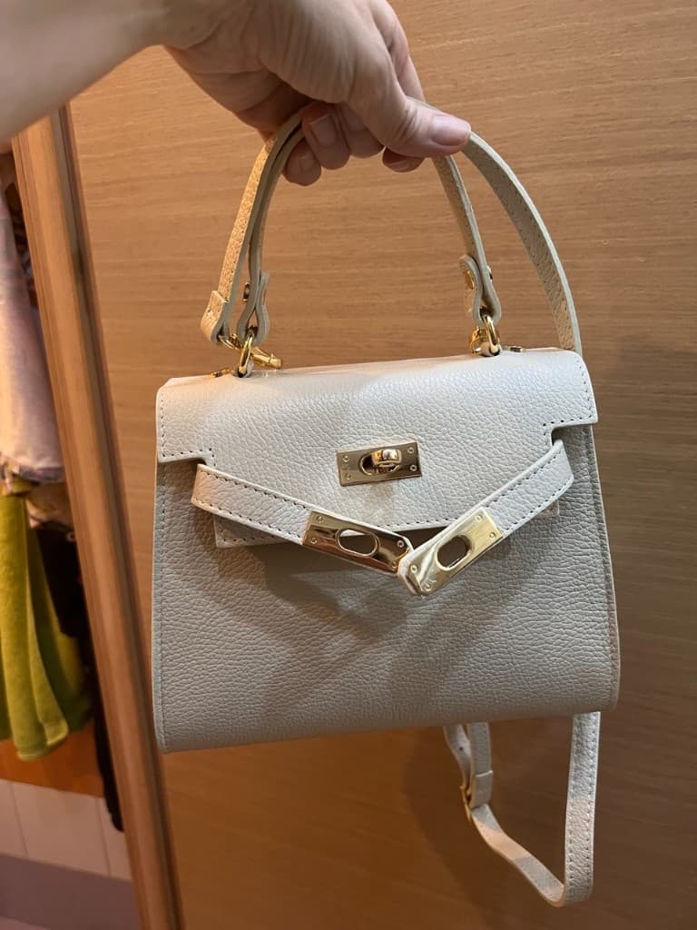 Beige handbag photographed at home